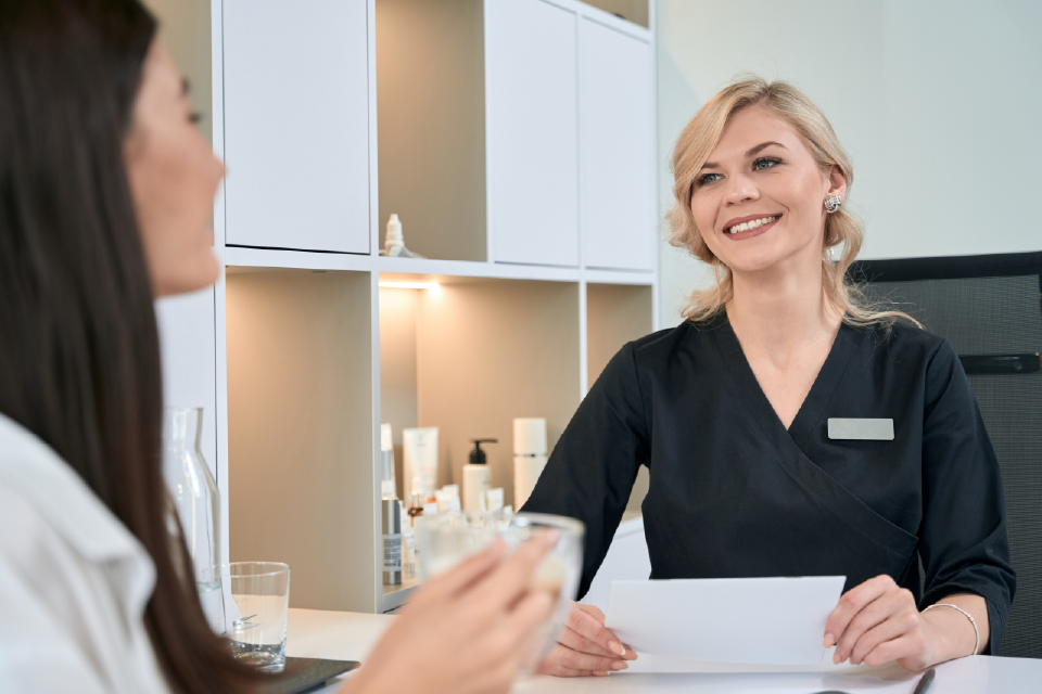 woman talking to receptionist at my purity spa